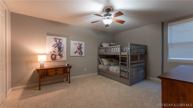 bedroom featuring ceiling fan and light carpet