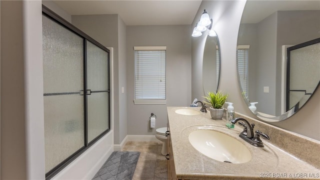 full bathroom with tile patterned floors, bath / shower combo with glass door, toilet, and sink