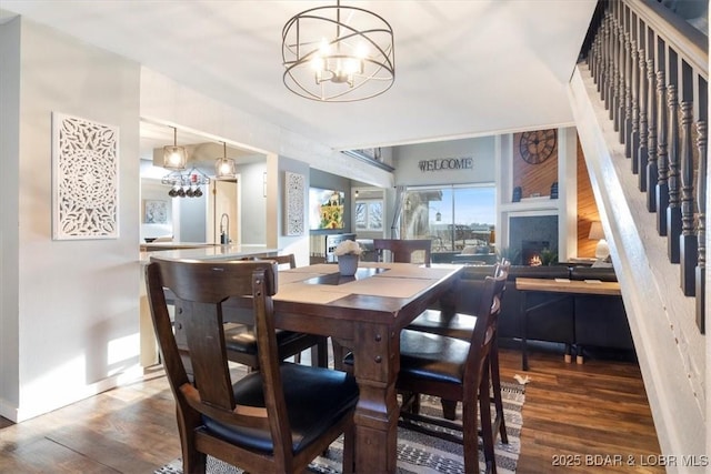 dining room with an inviting chandelier, dark hardwood / wood-style floors, and sink