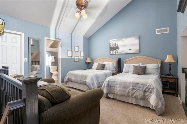 carpeted bedroom featuring lofted ceiling, ceiling fan, and ensuite bathroom