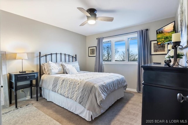 bedroom featuring light carpet and ceiling fan