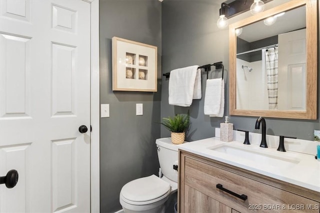 bathroom featuring vanity, curtained shower, and toilet