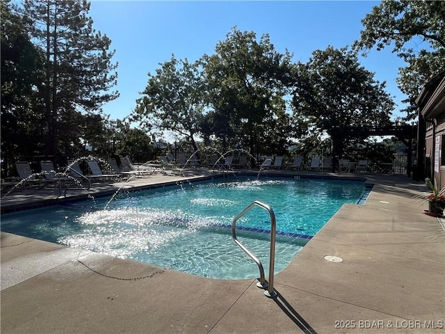 view of swimming pool with a patio area and pool water feature