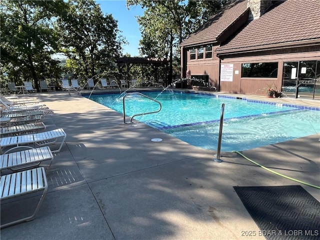 view of swimming pool with a patio