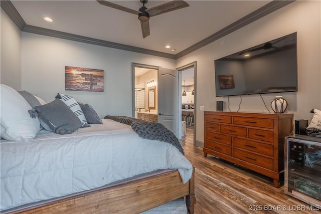 bedroom featuring hardwood / wood-style floors, ceiling fan, ornamental molding, and connected bathroom