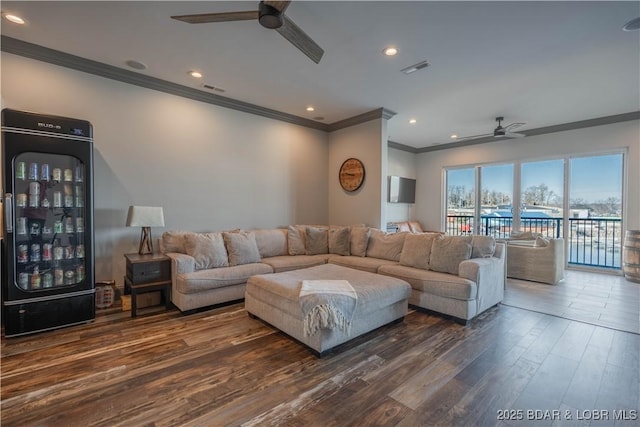 living room with ceiling fan, crown molding, and dark hardwood / wood-style floors