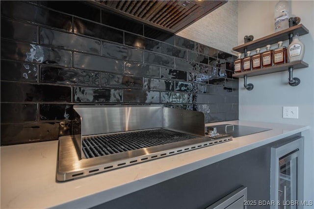 kitchen featuring backsplash and beverage cooler