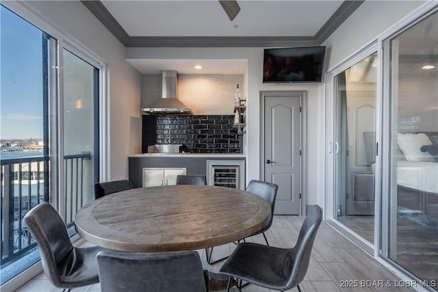 dining space featuring crown molding