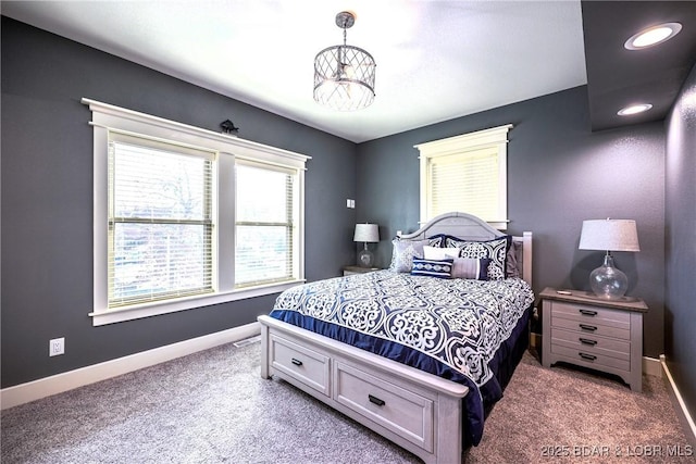 carpeted bedroom featuring a notable chandelier