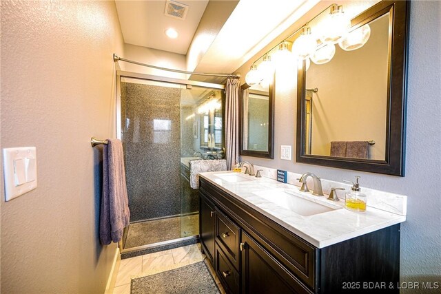 bathroom with vanity and an enclosed shower