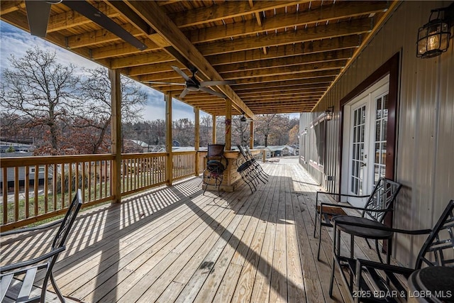 wooden deck with ceiling fan and french doors