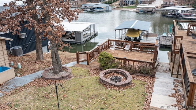 dock area with a water view, central AC unit, and an outdoor fire pit