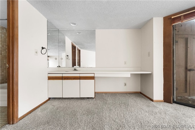 bathroom featuring a textured ceiling and vanity