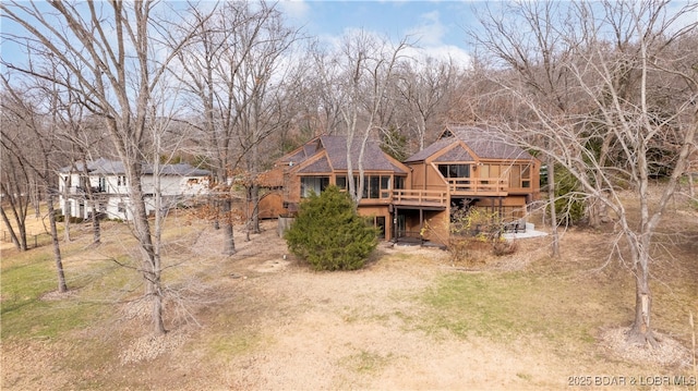 rear view of property featuring a deck