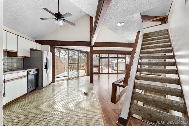 kitchen with backsplash, a textured ceiling, ceiling fan, white cabinets, and black dishwasher