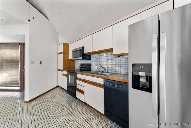 kitchen featuring black appliances, sink, white cabinetry, and backsplash