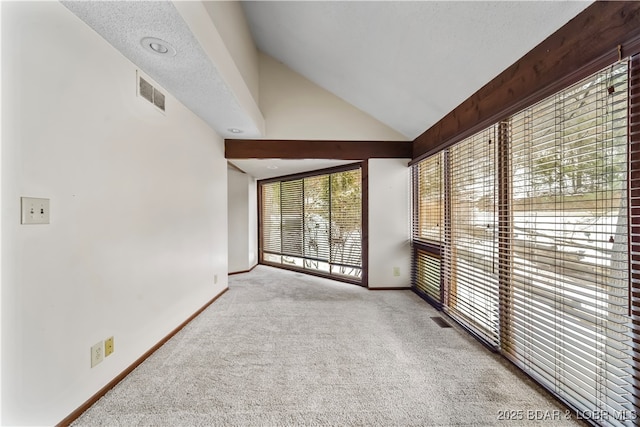 interior space featuring light colored carpet and vaulted ceiling