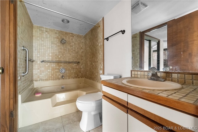 full bathroom with tile patterned flooring, vanity, toilet, and tiled shower / bath