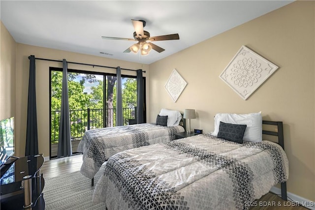 bedroom featuring access to exterior, hardwood / wood-style flooring, and ceiling fan