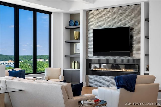 living room with hardwood / wood-style floors and built in shelves