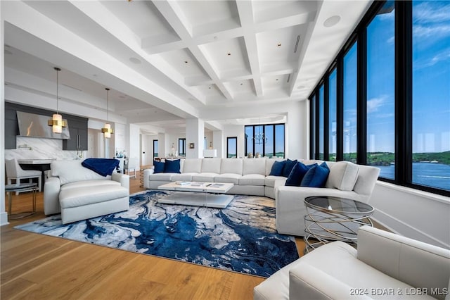 living room with beam ceiling, coffered ceiling, and hardwood / wood-style flooring