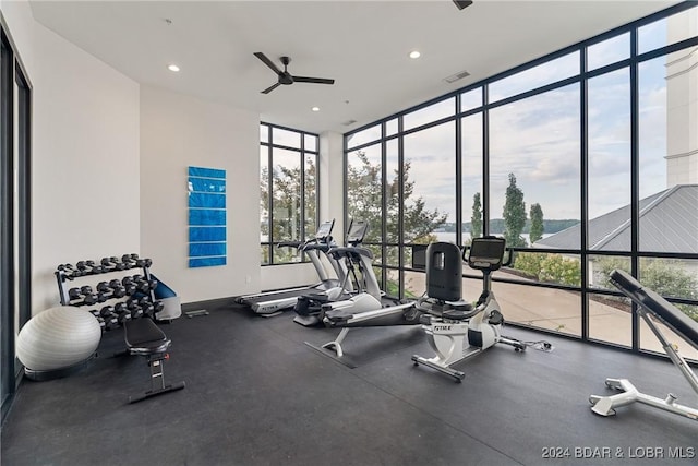 gym with ceiling fan and floor to ceiling windows