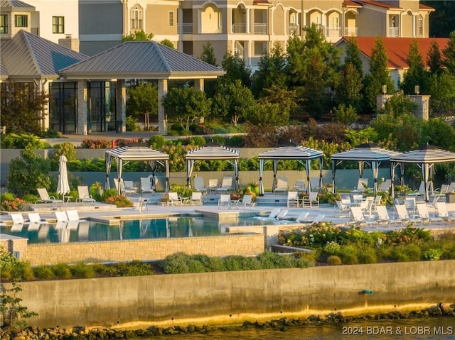 surrounding community with a gazebo, a patio area, and a swimming pool