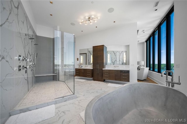 bathroom featuring vanity, expansive windows, independent shower and bath, and an inviting chandelier