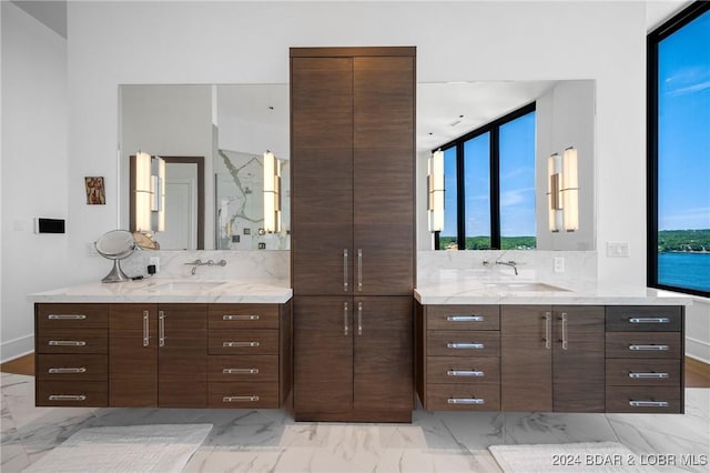 bathroom featuring vanity, a water view, and decorative backsplash