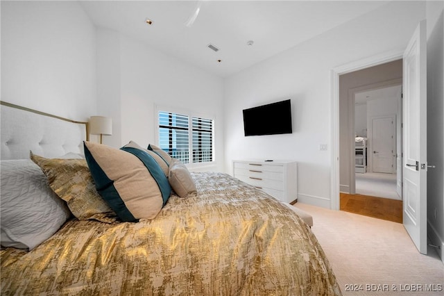 bedroom featuring light colored carpet