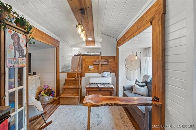 sitting room with lofted ceiling, wooden walls, and wood ceiling