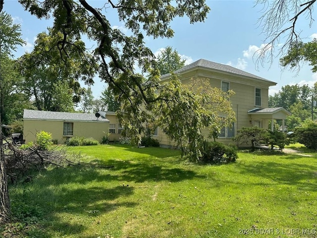 back of house with a lawn