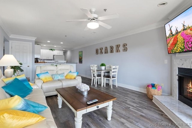 1481 Ledges Dr Unit C-14, Osage Beach, MO 65065 - living room featuring ceiling fan, a high end fireplace, crown molding, baseboards, and wood finished floors