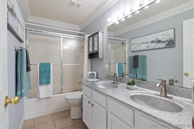 full bathroom with combined bath / shower with glass door, tile patterned floors, crown molding, toilet, and vanity