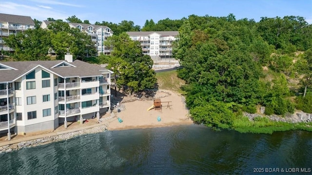 birds eye view of property with a water view