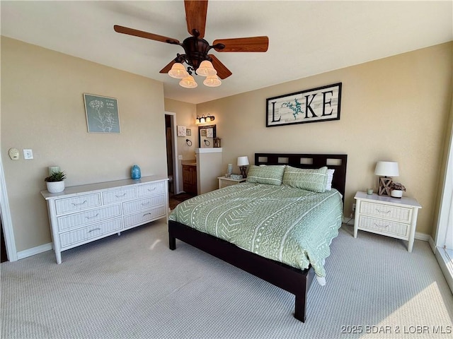 2500 Bay Point Ln Unit 234, Osage Beach, MO 65065 - bedroom with baseboards, ensuite bathroom, carpet flooring, and ceiling fan