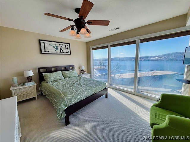 2500 Bay Point Ln Unit 234, Osage Beach, MO 65065 - bedroom with a ceiling fan, visible vents, access to exterior, and carpet floors