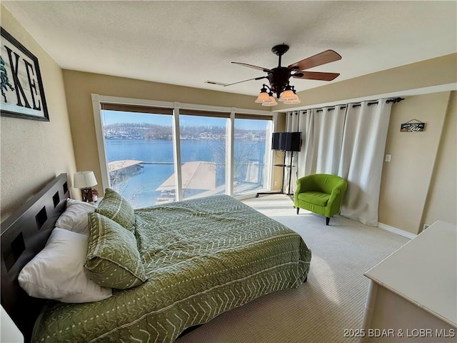 2500 Bay Point Ln Unit 234, Osage Beach, MO 65065 - carpeted bedroom featuring a water view, access to outside, and ceiling fan