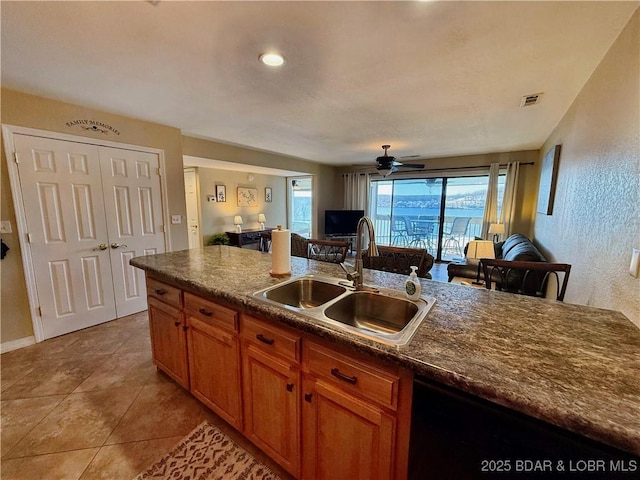 2500 Bay Point Ln Unit 234, Osage Beach, MO 65065 - kitchen featuring a sink, black dishwasher, brown cabinets, visible vents, and a ceiling fan