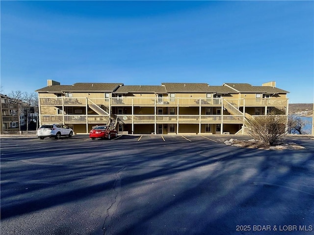 2500 Bay Point Ln Unit 234, Osage Beach, MO 65065 - exterior space with uncovered parking and stairs