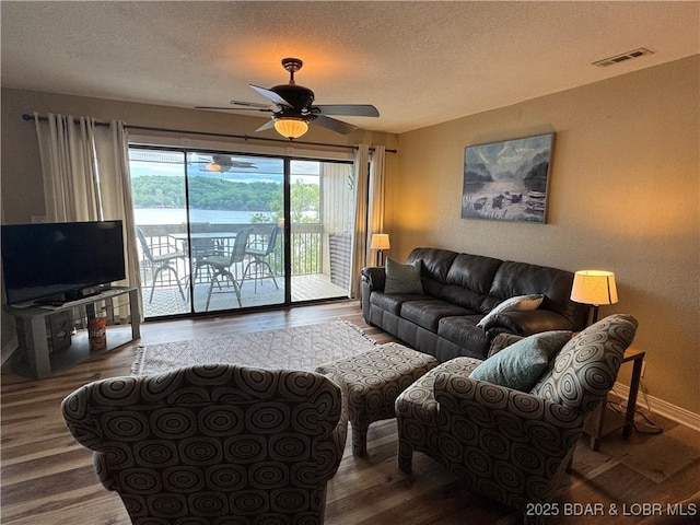 2500 Bay Point Ln Unit 234, Osage Beach, MO 65065 - living room featuring a ceiling fan, visible vents, a textured ceiling, and wood finished floors