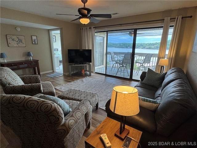 2500 Bay Point Ln Unit 234, Osage Beach, MO 65065 - living room featuring a ceiling fan, visible vents, and wood finished floors
