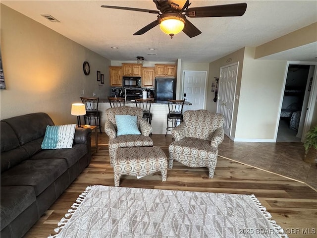 2500 Bay Point Ln Unit 234, Osage Beach, MO 65065 - living room featuring ceiling fan, light wood-style flooring, baseboards, and visible vents
