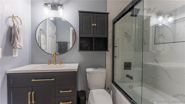 full bathroom with vanity, toilet, and shower / bath combination with glass door