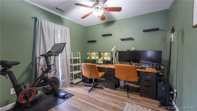 home office with ceiling fan and light hardwood / wood-style flooring