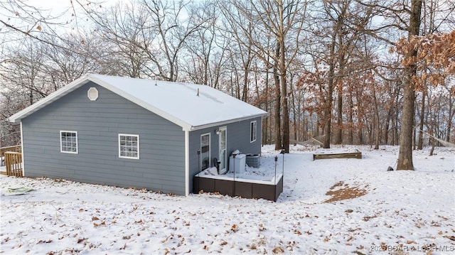 snow covered house with cooling unit