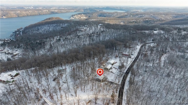 snowy aerial view with a water view