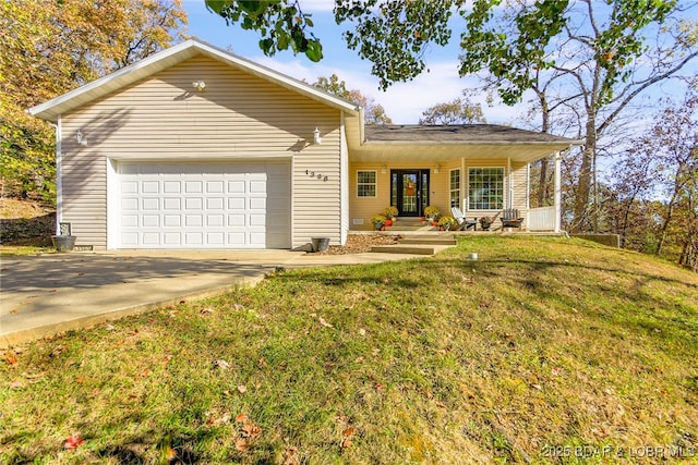 ranch-style house featuring a garage, a front lawn, and a porch