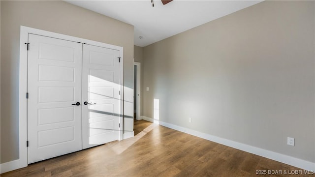 unfurnished bedroom with a closet and wood-type flooring