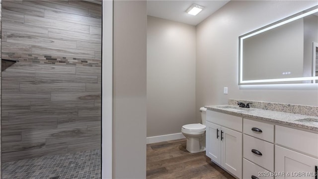 bathroom featuring toilet, vanity, and hardwood / wood-style flooring